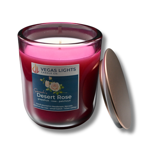 Vegas Lights Candle Co. candle with a red glass jar and visible label on a light gray background