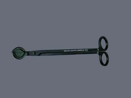 A wick trimmer labeled with the Vegas Light Candle Company name