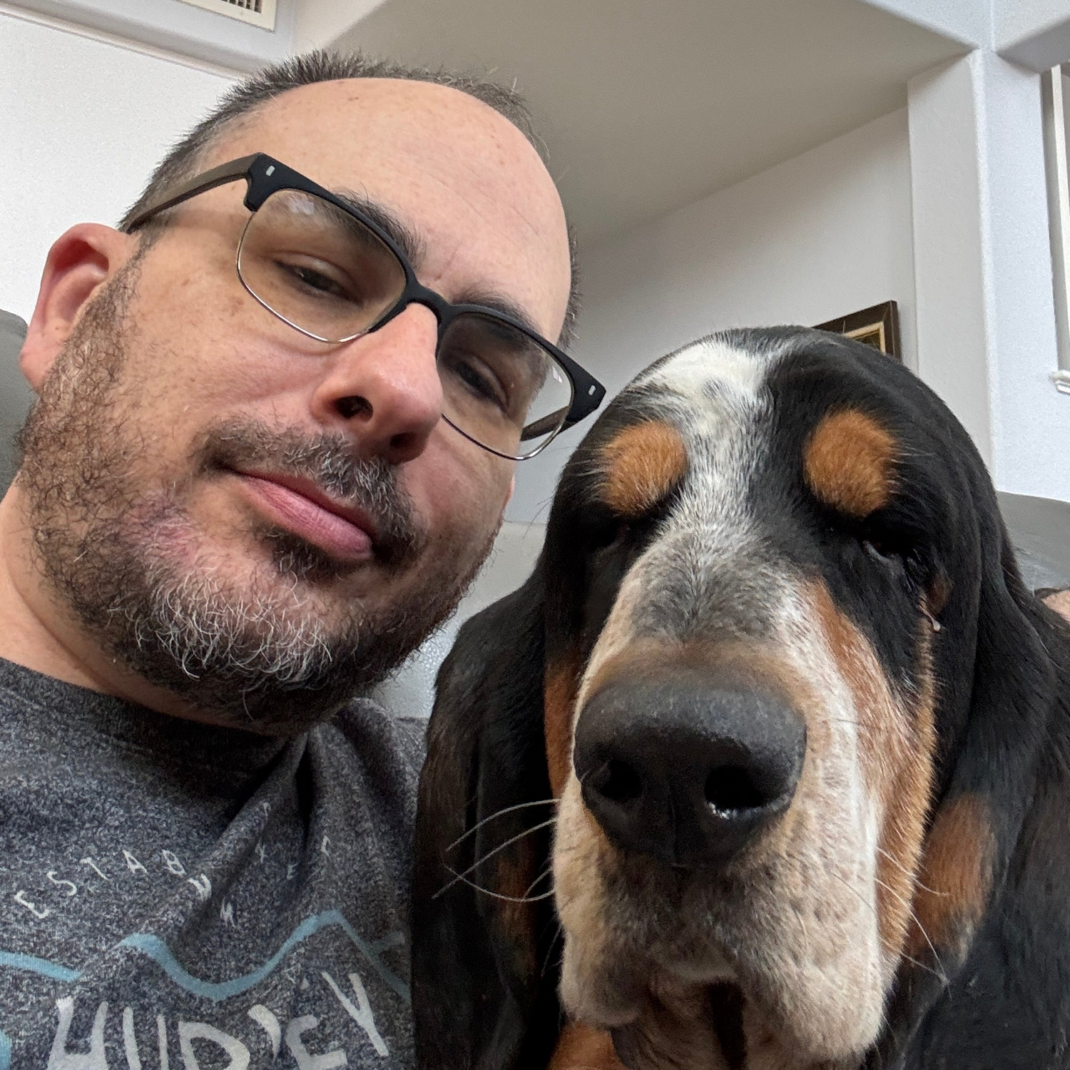 Vegas Lights Candle Co. owner with his dog in an indoor setting.