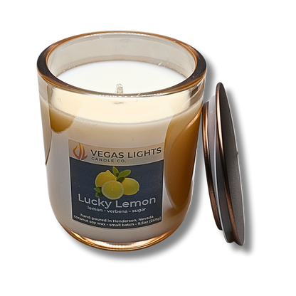 Vegas Lights Candle Co. Lucky Lemon candle with a champagne luster glass jar and bronze lid on a white background