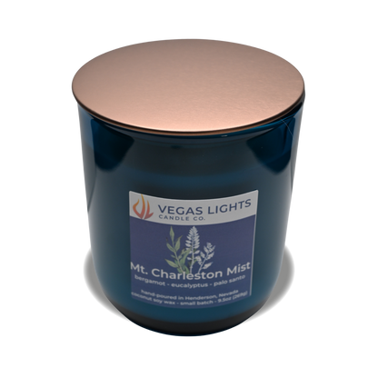 Blue candle with a copper lid and 'Vegas Lights Candle Co.' label on a white background