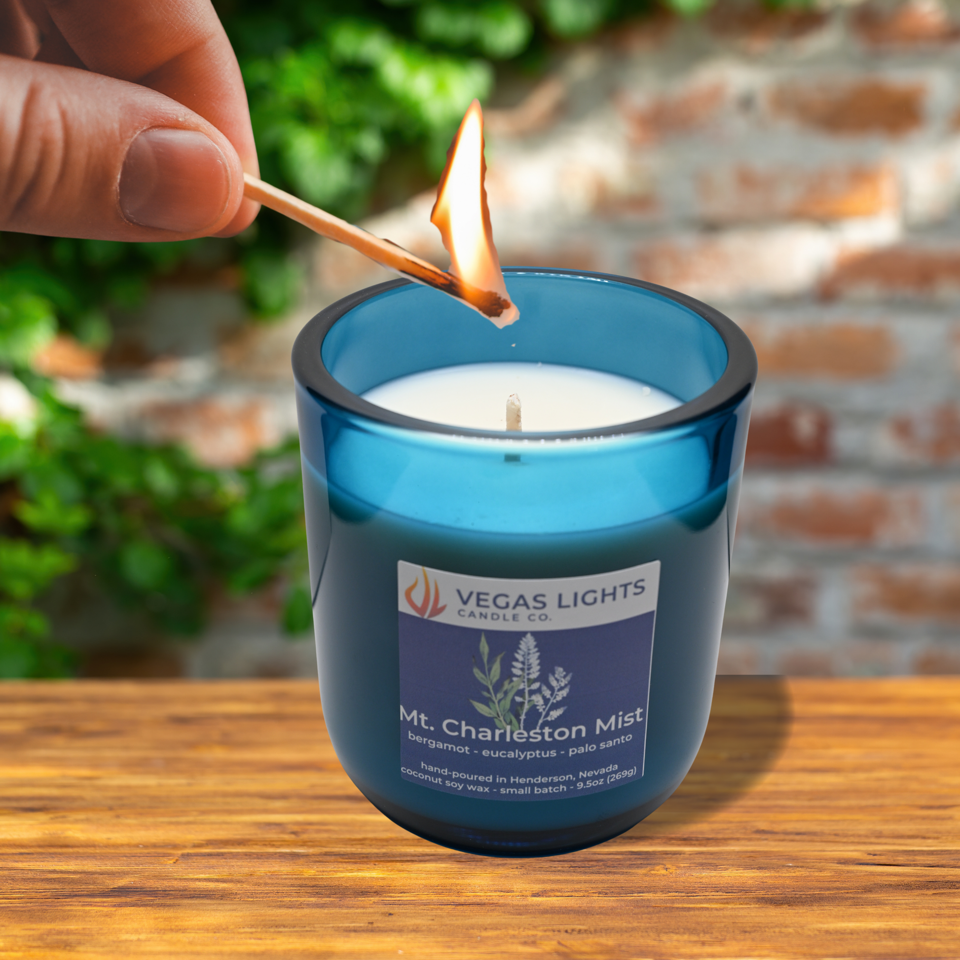 Vegas Lights candle being lit with a match outdoors