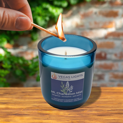 Vegas Lights candle being lit with a match outdoors