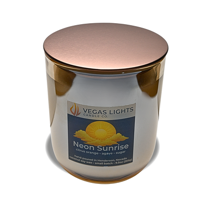 Vegas Lights Candle Co. candle with a bronze lid on a white background