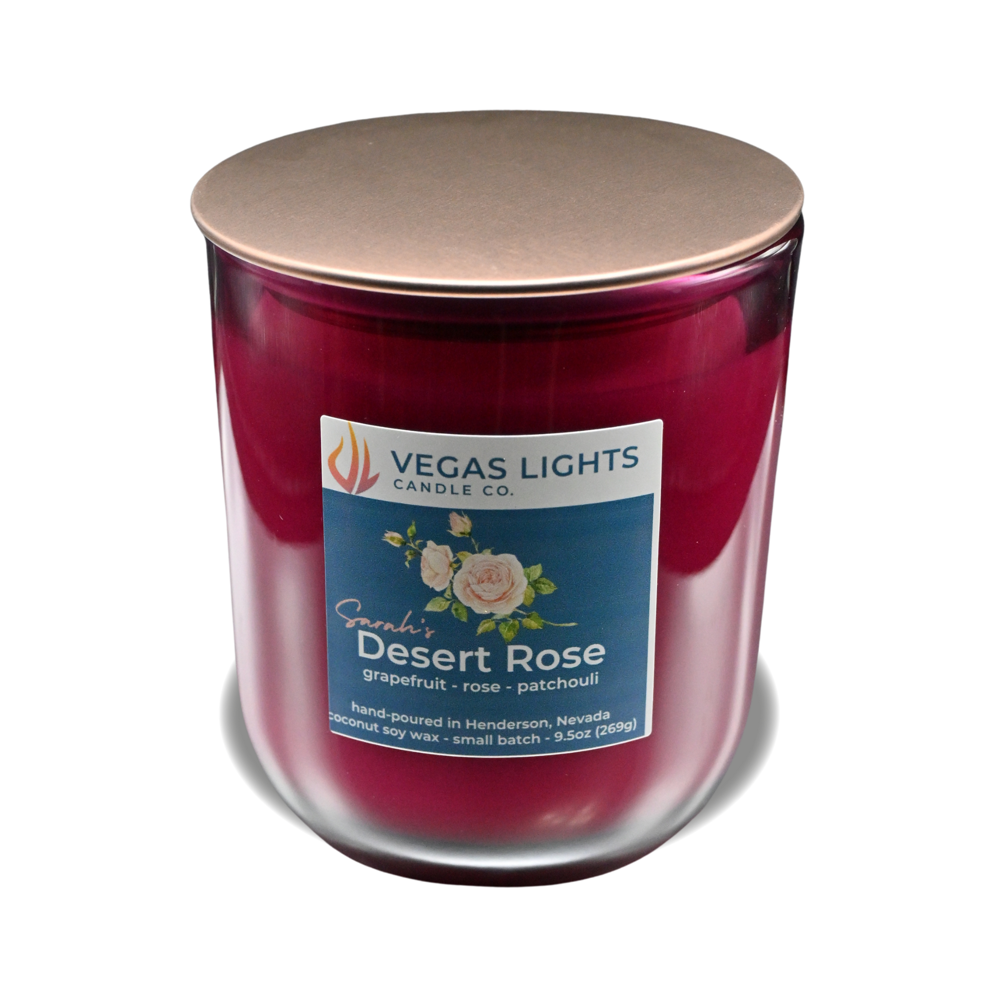 Vegas Lights Candle Co. candle in a red jar with a bronze lid on a white background