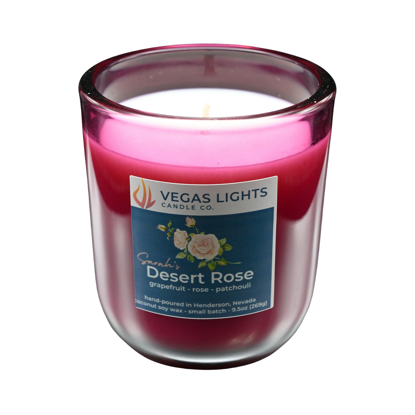 Vegas Lights Candle Co. Sarah's Desert Rose candle in a red glass jar with a white base on a white background