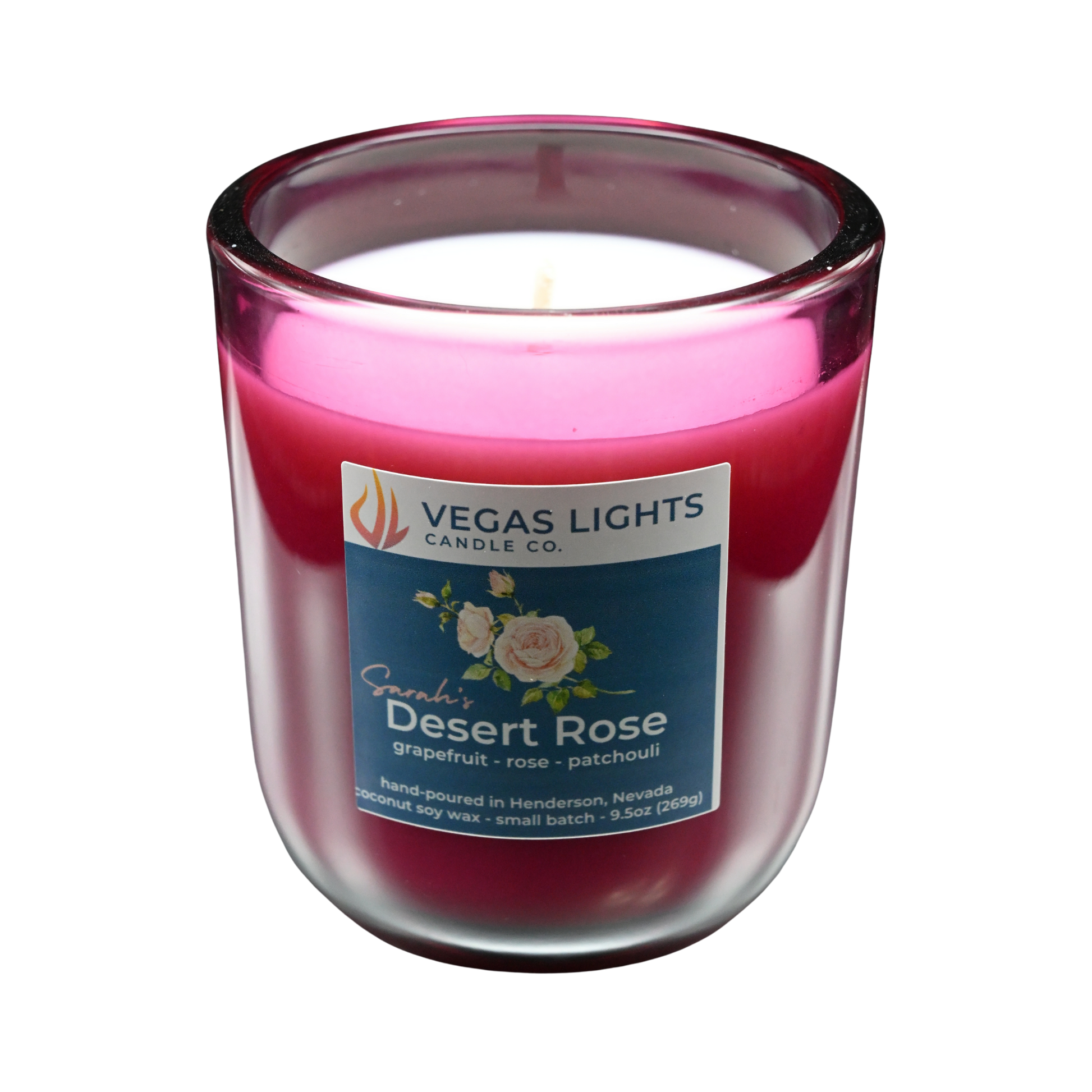 Vegas Lights Candle Co. Sarah's Desert Rose candle in a red glass jar with a white base on a white background