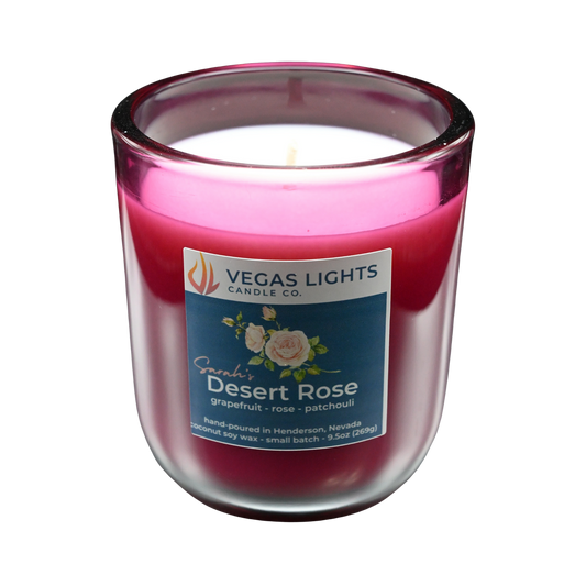 Vegas Lights Candle Co. Sarah's Desert Rose candle in a red glass jar with a white base on a white background