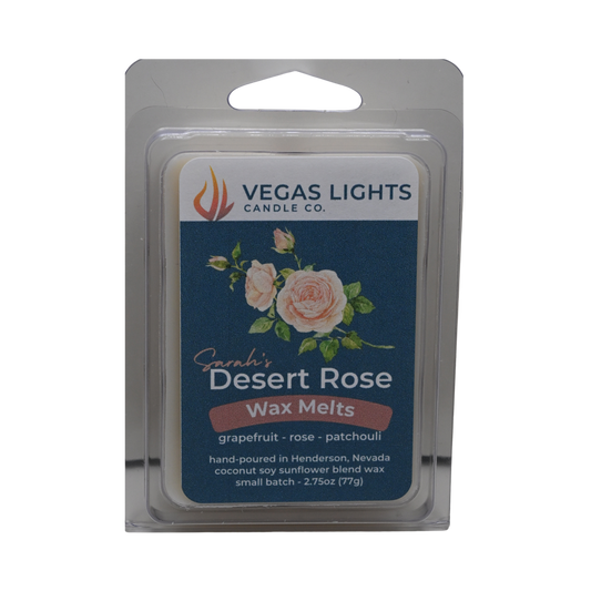 Vegass Lights Candle Co. Desert Rose wax melts packaging with floral decorations on a blue background