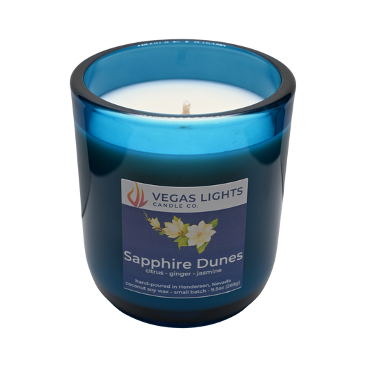 Vegas Lights Candle Co. Sapphire Dunes candle in a blue glass container on a white background