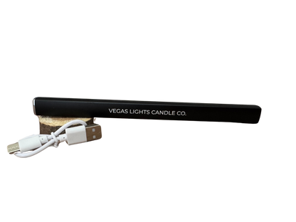 Black lighter with USB cable and wooden base on a white background, branded 'Vegas Lights Candle Co'.